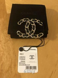 BEAUTIFUL AUTHENTIC CHANEL brooch golden with black leather. NEW WITH TAG in BOX