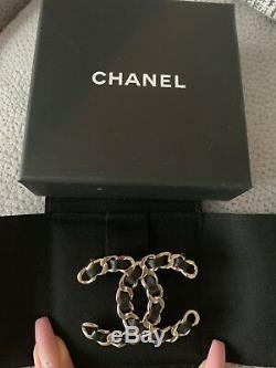 Chanel large brooch worn two times. Beautiful piece with black leather